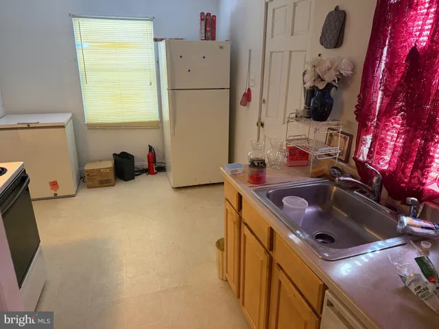 a kitchen with a sink and a refrigerator
