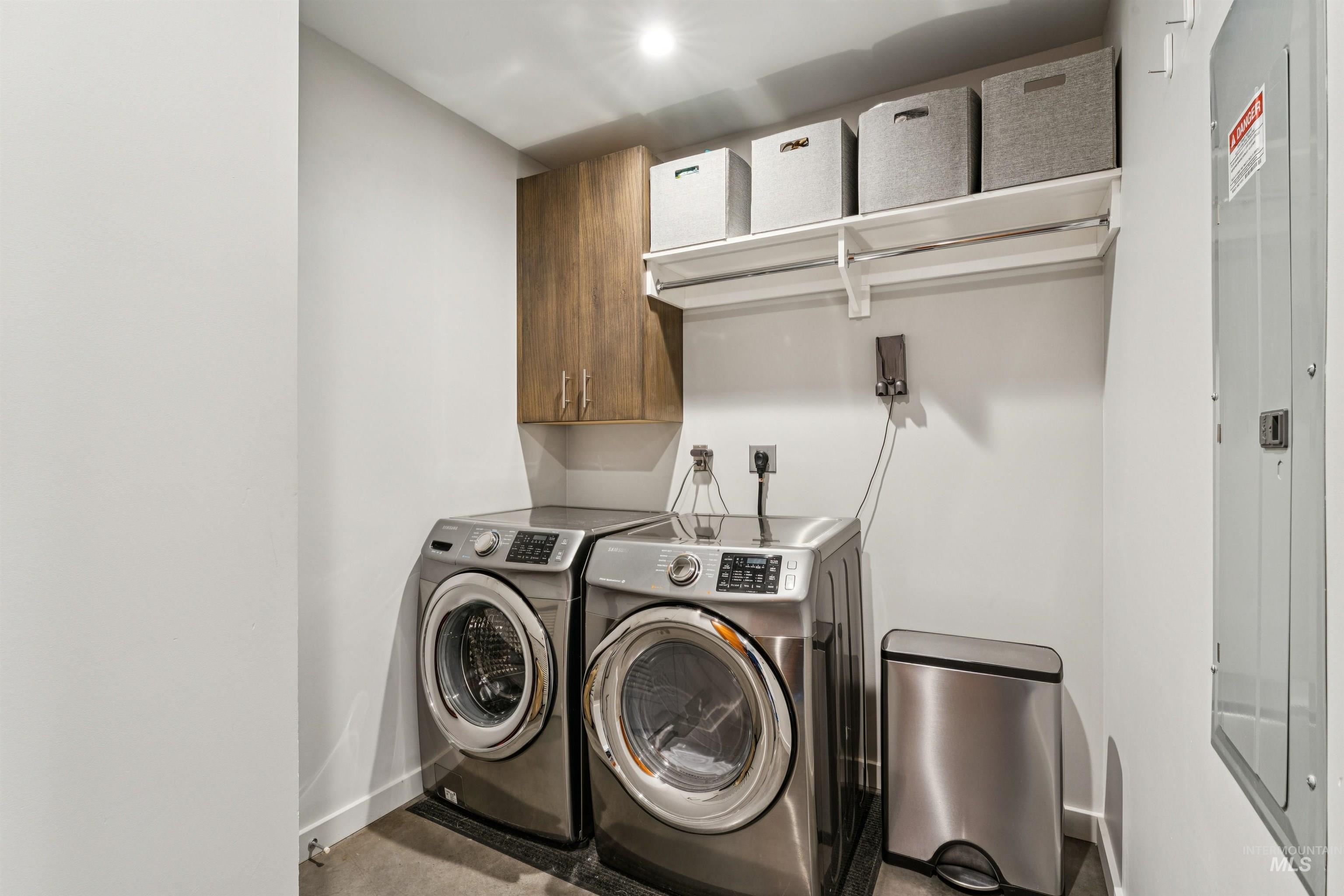 119 South 10th Street, Unit 307 Boise, ID 83702 - Photo 34 of 47 Dedicated laundry space featuring a wood-finish upper cabinet, white shelving, and a garment rod