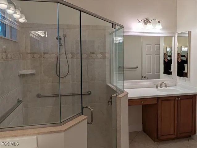 a bathroom with a shower sink and mirror