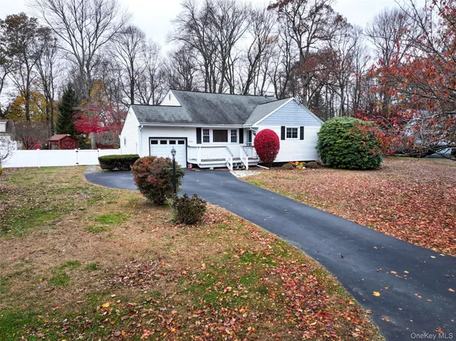 a front view of house with yard covered in snow
