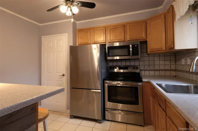 a kitchen with a refrigerator sink and microwave