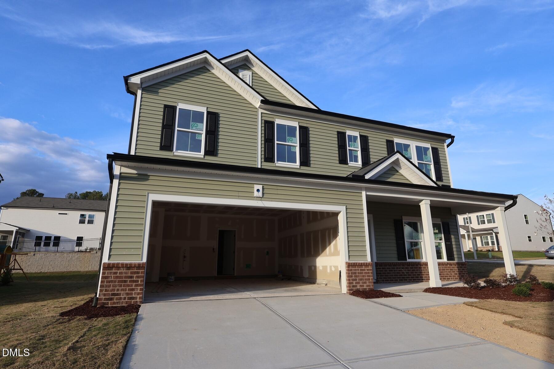 1321 Dimaggio Drive Raleigh, NC 27616 - Photo 2 of 28 a front view of a house with a garage