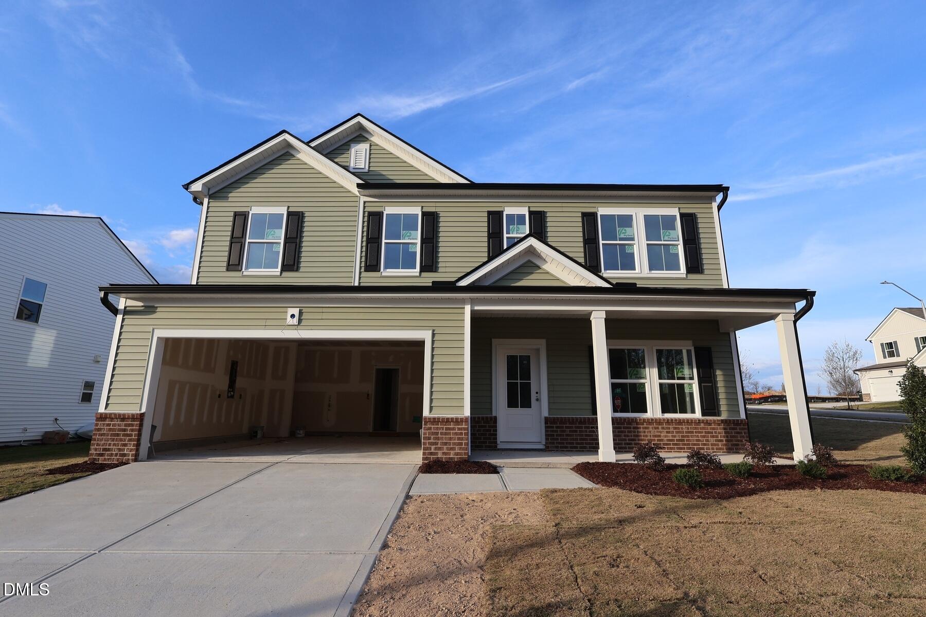 1321 Dimaggio Drive Raleigh, NC 27616 - Photo 3 of 28 a front view of a house with a yard and garage