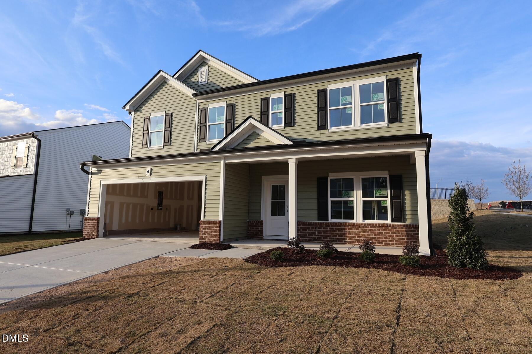 1321 Dimaggio Drive Raleigh, NC 27616 - Photo 4 of 28 a front view of a house with a yard and garage