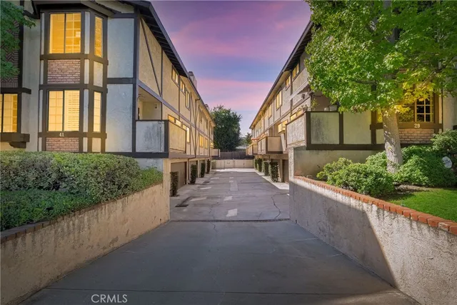 a view of a pathway both side of house