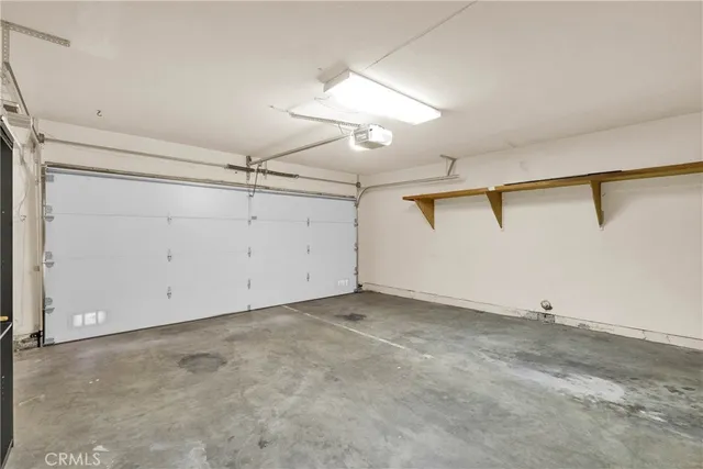 an empty room with ceiling fan and window