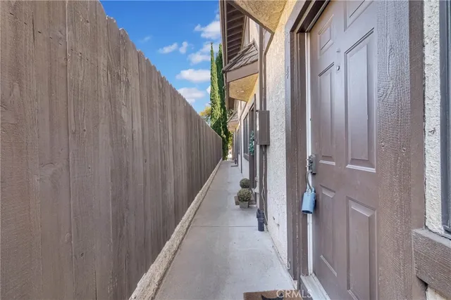 a view of a hallway with a white door and stairs