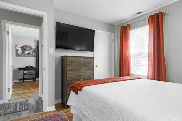 a bedroom with a bed and a mirror