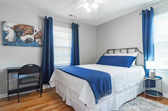 a living room with a baby crib and a couch