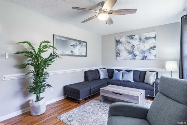 a living room with furniture potted plant and a window