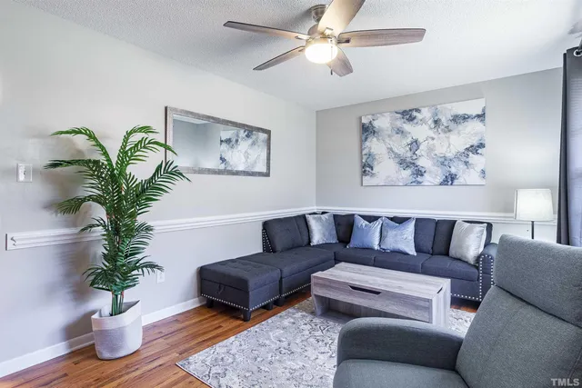 a living room with furniture potted plant and a window