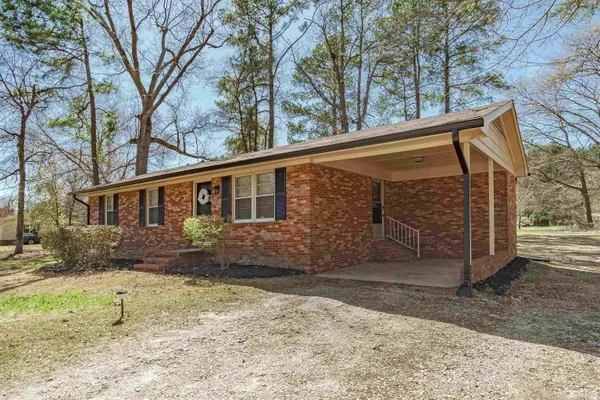 a view of a house with a yard covered in snow