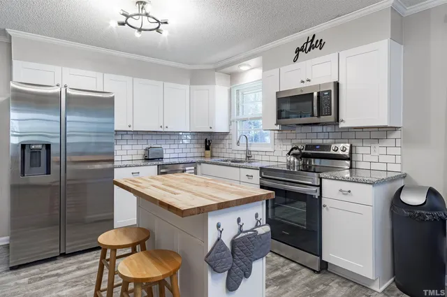 a kitchen with a sink stove and refrigerator