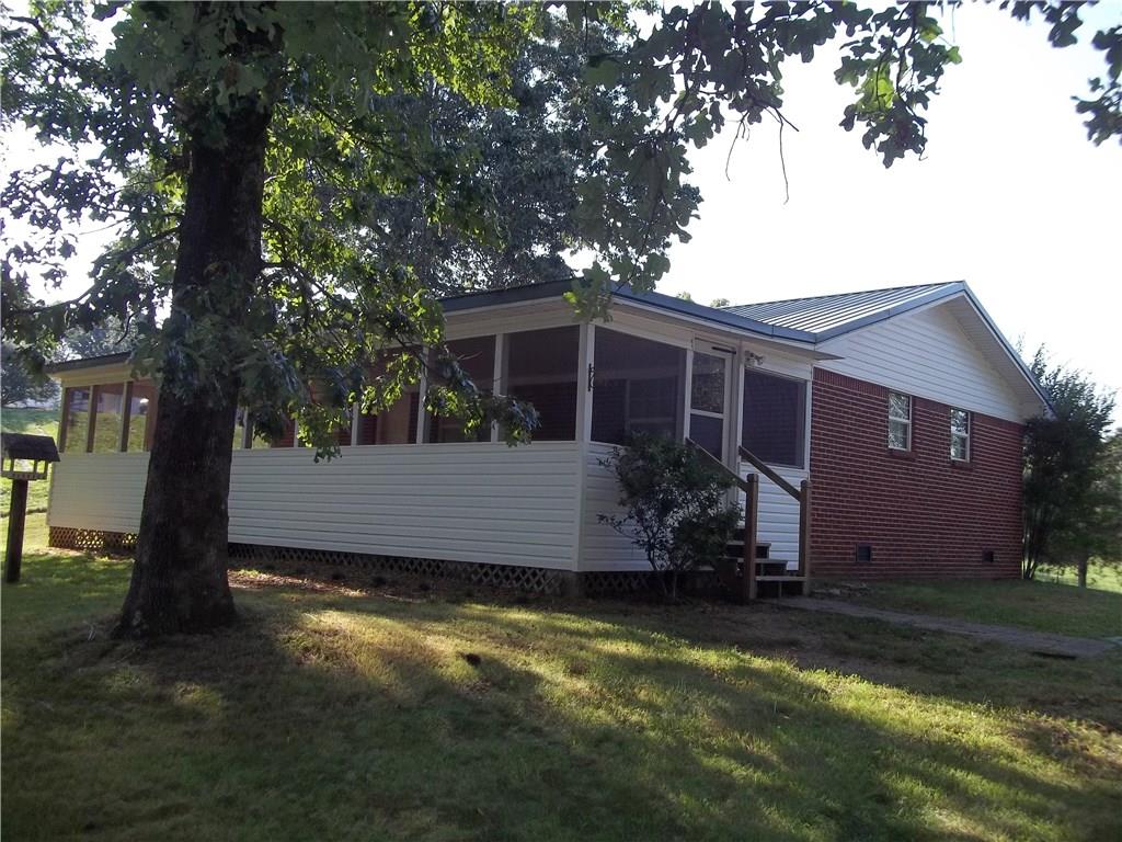 590 Old Boone Ford Road Southeast Calhoun, GA 30701 - Photo 1 of 1 a view of a house with a yard garage and tree