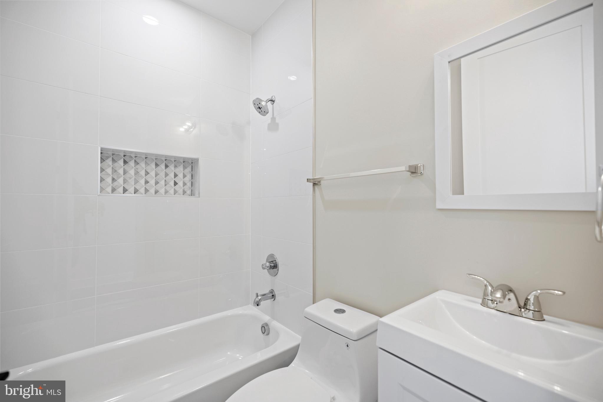 824 18th Street Northeast, Unit 12 Washington, DC 20002 - Photo 11 of 25 a bathroom with a sink a toilet and shower