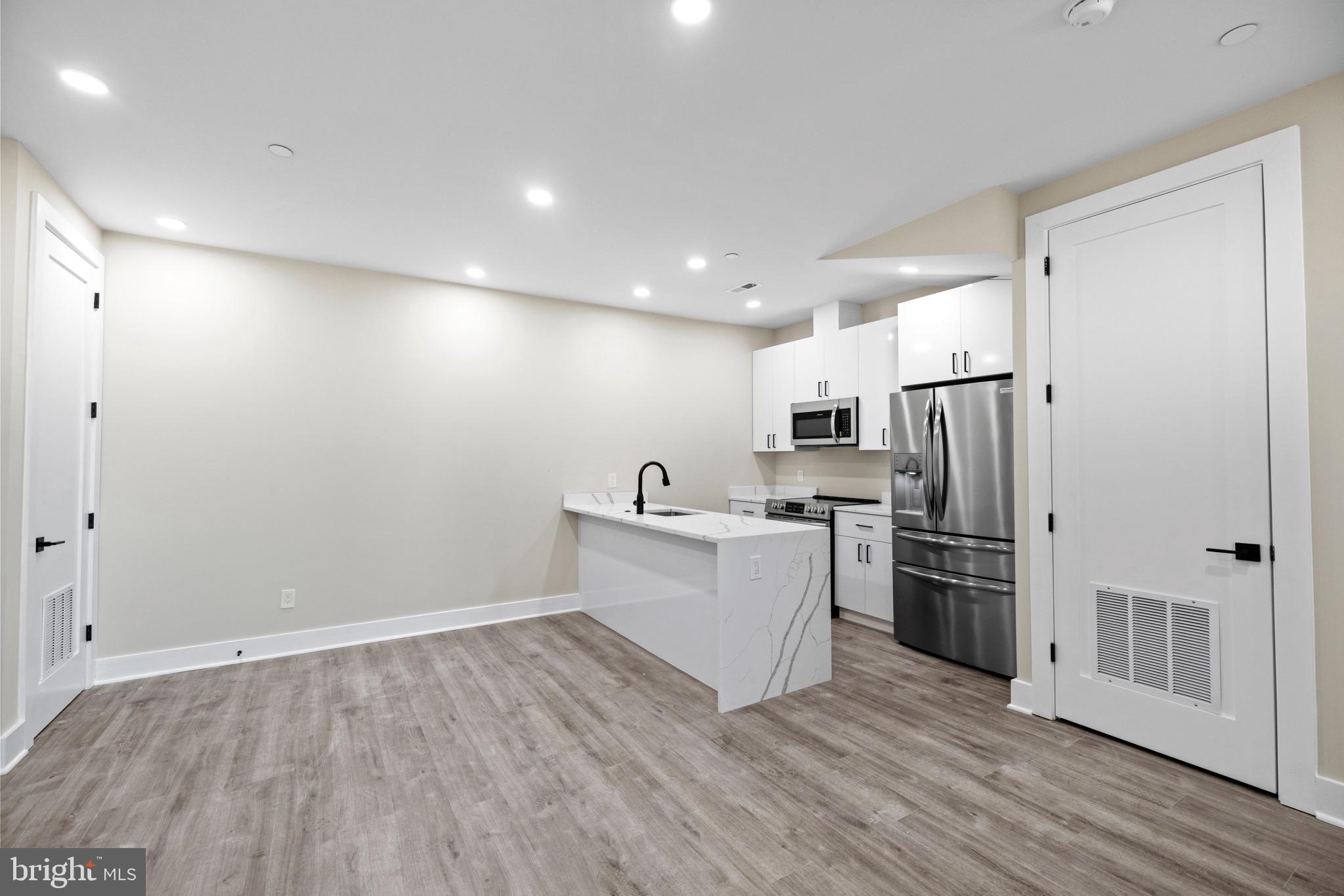 824 18th Street Northeast, Unit 12 Washington, DC 20002 - Photo 18 of 25 a view of a kitchen with refrigerator stove and wooden cabinets