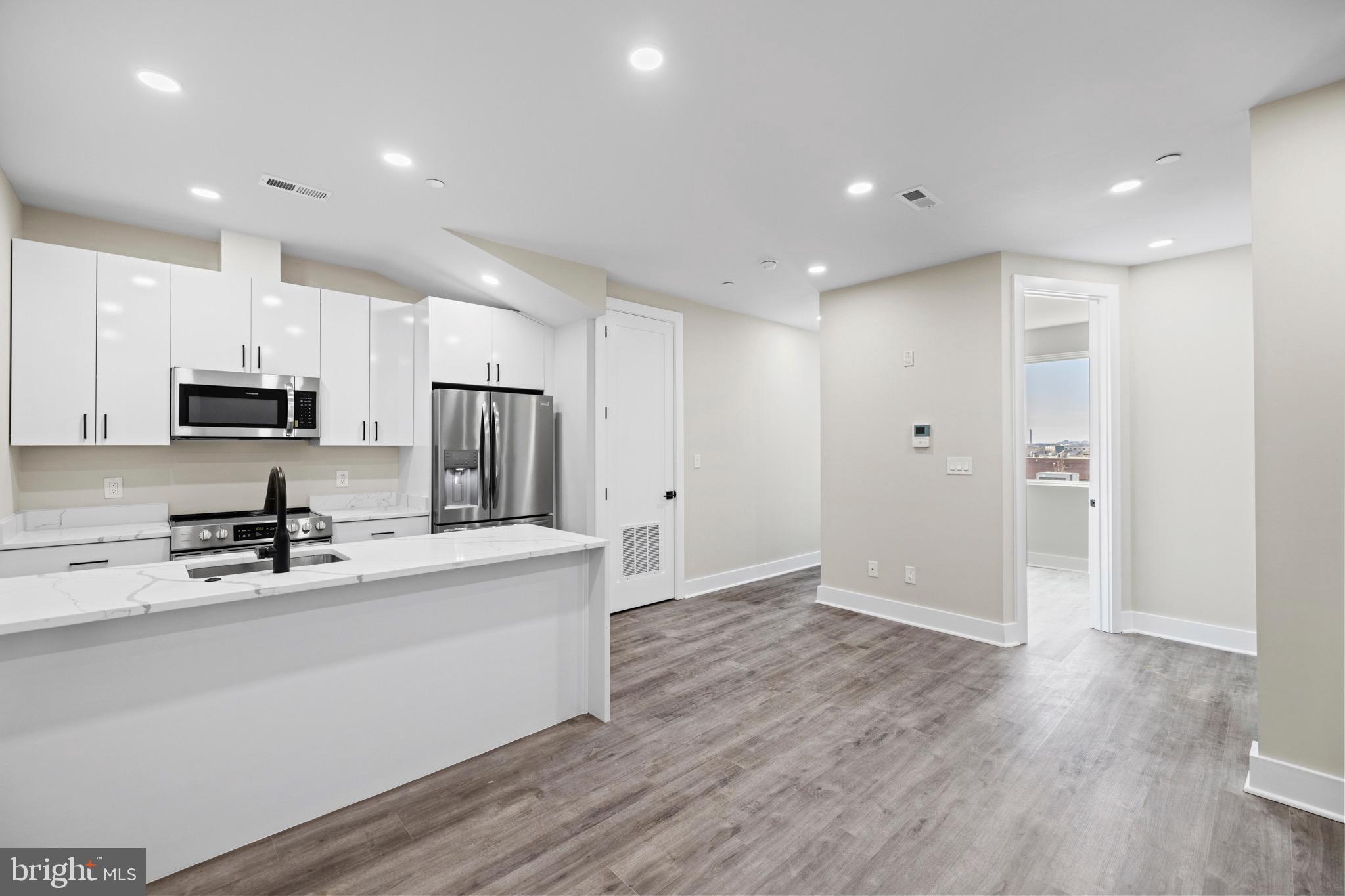 824 18th Street Northeast, Unit 12 Washington, DC 20002 - Photo 19 of 25 a kitchen with stainless steel appliances a refrigerator sink and microwave