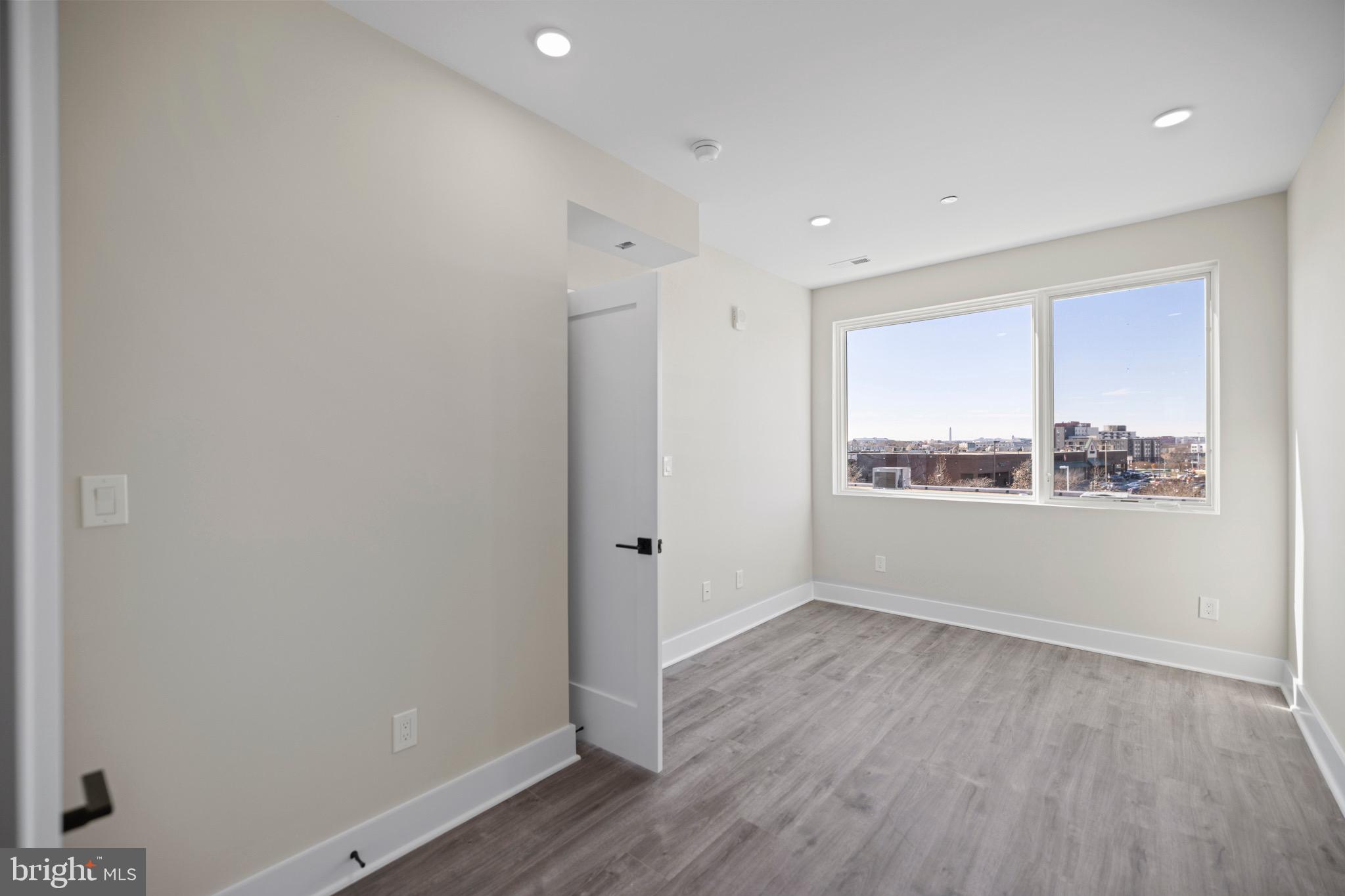 824 18th Street Northeast, Unit 12 Washington, DC 20002 - Photo 10 of 25 a view of an empty room with wooden floor and a window