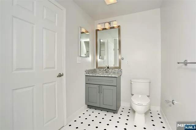 a bathroom with a sink a toilet and a mirror
