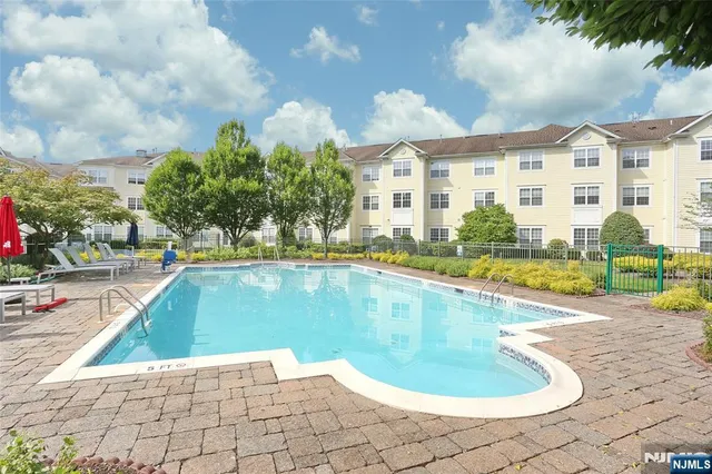 a view of a swimming pool with a lounge chairs