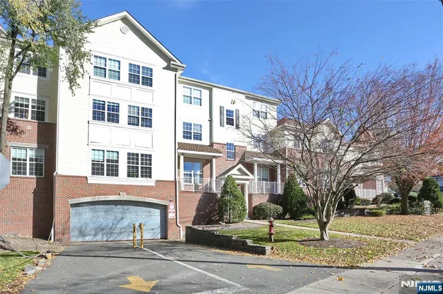 a living room with a large bed and a chandelier