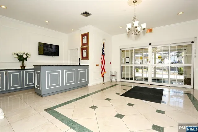 a living room with furniture and a chandelier