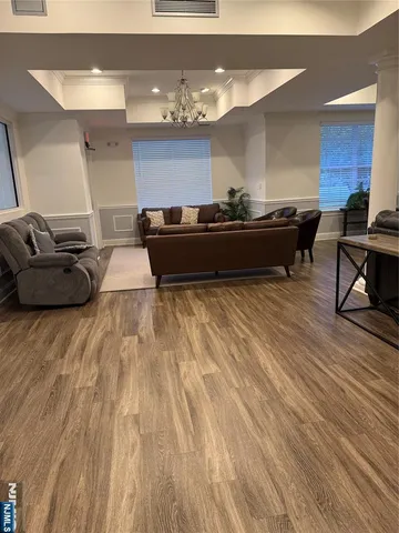 a living room with furniture and a chandelier