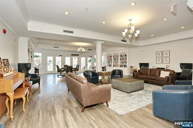 a living room with furniture dining table a chandelier a rug and a chandelier