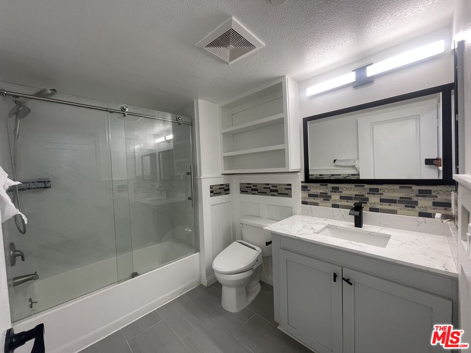1401 Lomita Boulevard, Unit 205 Harbor City, CA 90710 - Photo 13 of 19 a bathroom with a bathtub shower sink vanity mirror and toilet