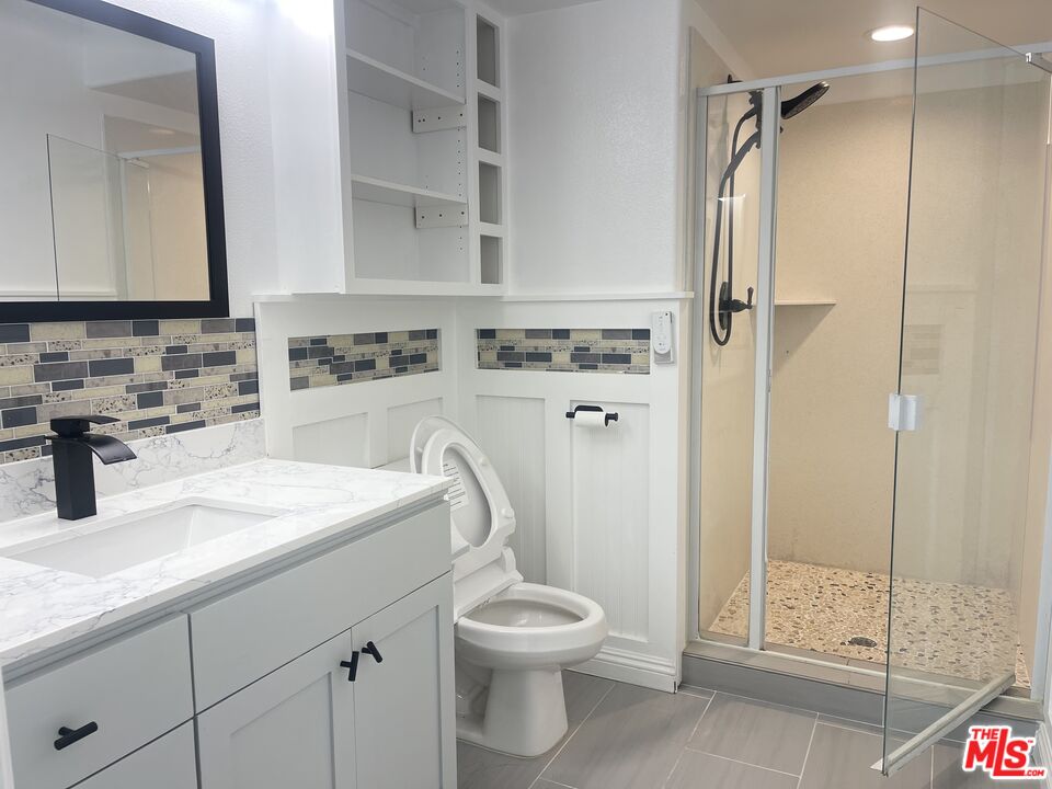 1401 Lomita Boulevard, Unit 205 Harbor City, CA 90710 - Photo 18 of 19 a bathroom with a sink toilet and shower