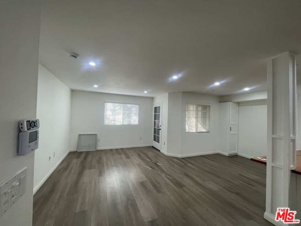 1401 Lomita Boulevard, Unit 205 Harbor City, CA 90710 - Photo 7 of 19 an empty room with wooden floor and windows