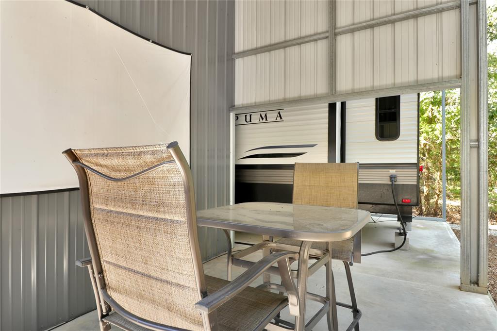 405 Broken Bow Quitman, TX 75783 - Photo 15 of 33 Covered concrete patio with projector TV