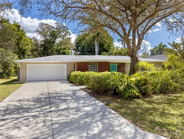 a front view of a house with a yard and a garage