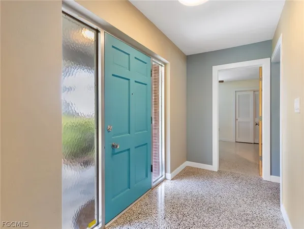 a view of hallway with a bathroom and a mirror