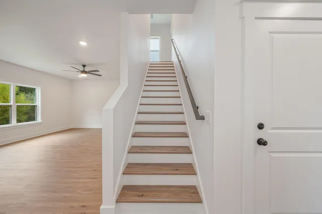 a view of entryway and hall with wooden floor