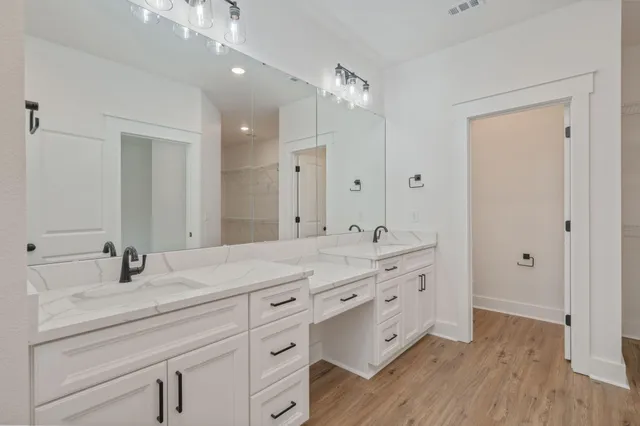 a bathroom with a double vanity sink and a mirror