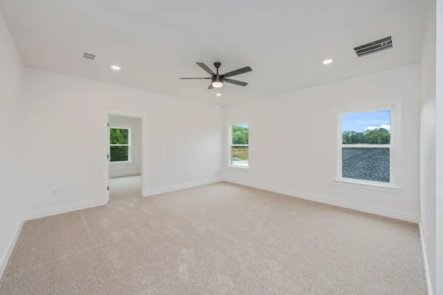 an empty room with fan and ceiling fan