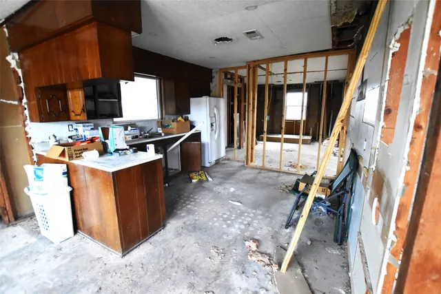 a view of a hallway with furniture and front door