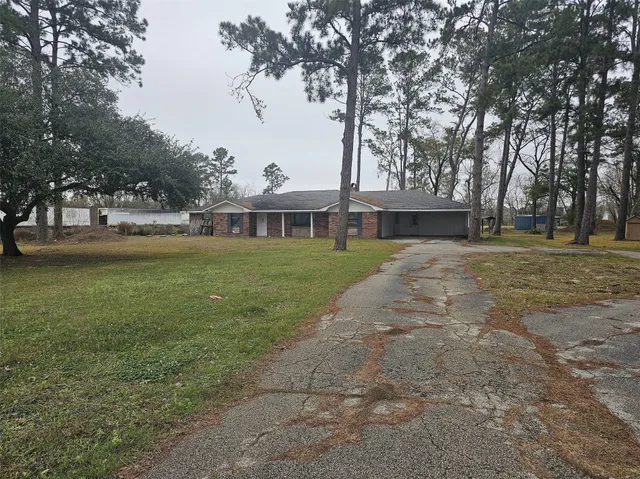a view of a field with an trees in the background