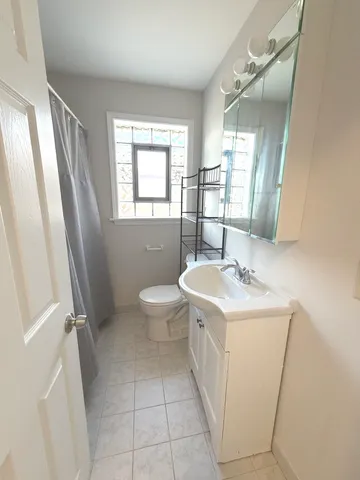 a bathroom with a sink a toilet and mirror