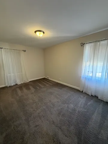 an empty room with a empty space and windows