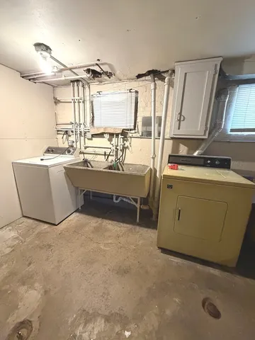 a room with a washing machine and mirrors