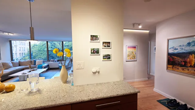 a dining room with furniture a chandelier and wooden floor