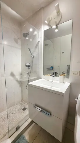 a bathroom with a tub and a view of walk in closet