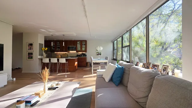 a living room with lots of furniture and large windows