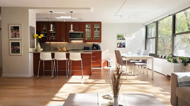 a kitchen with stainless steel appliances a sink stove and cabinets