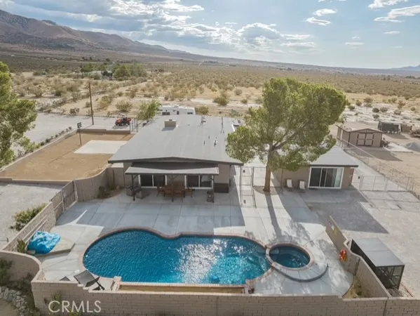 a view of a house with pool and ocean view