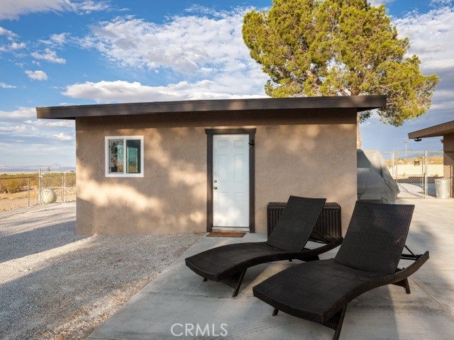 30280 Santa Rosa Road Lucerne Valley, CA 92356 - Photo 17 of 61 a backyard of a house with table and chairs
