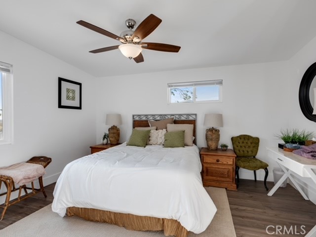 30280 Santa Rosa Road Lucerne Valley, CA 92356 - Photo 23 of 61 a bedroom with a bed a couch and a chandelier