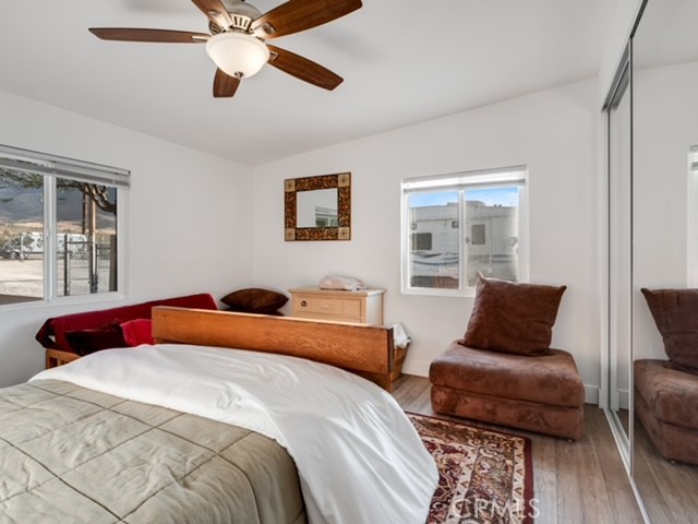 30280 Santa Rosa Road Lucerne Valley, CA 92356 - Photo 26 of 61 a bedroom with a bed and wooden floor